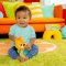 BRIGHT STARTS Spielzeug mit Melodie am C-Ring Löwe Huggin' Lights ™0m+