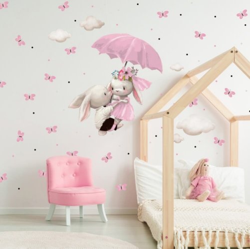 Vinilo para la pared - Conejitos volando sobre un paraguas rosa