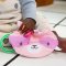 INGENUITY Sensorik-Spielzeug am C-Ring Crinklet™ Waschbär Deni 0m+